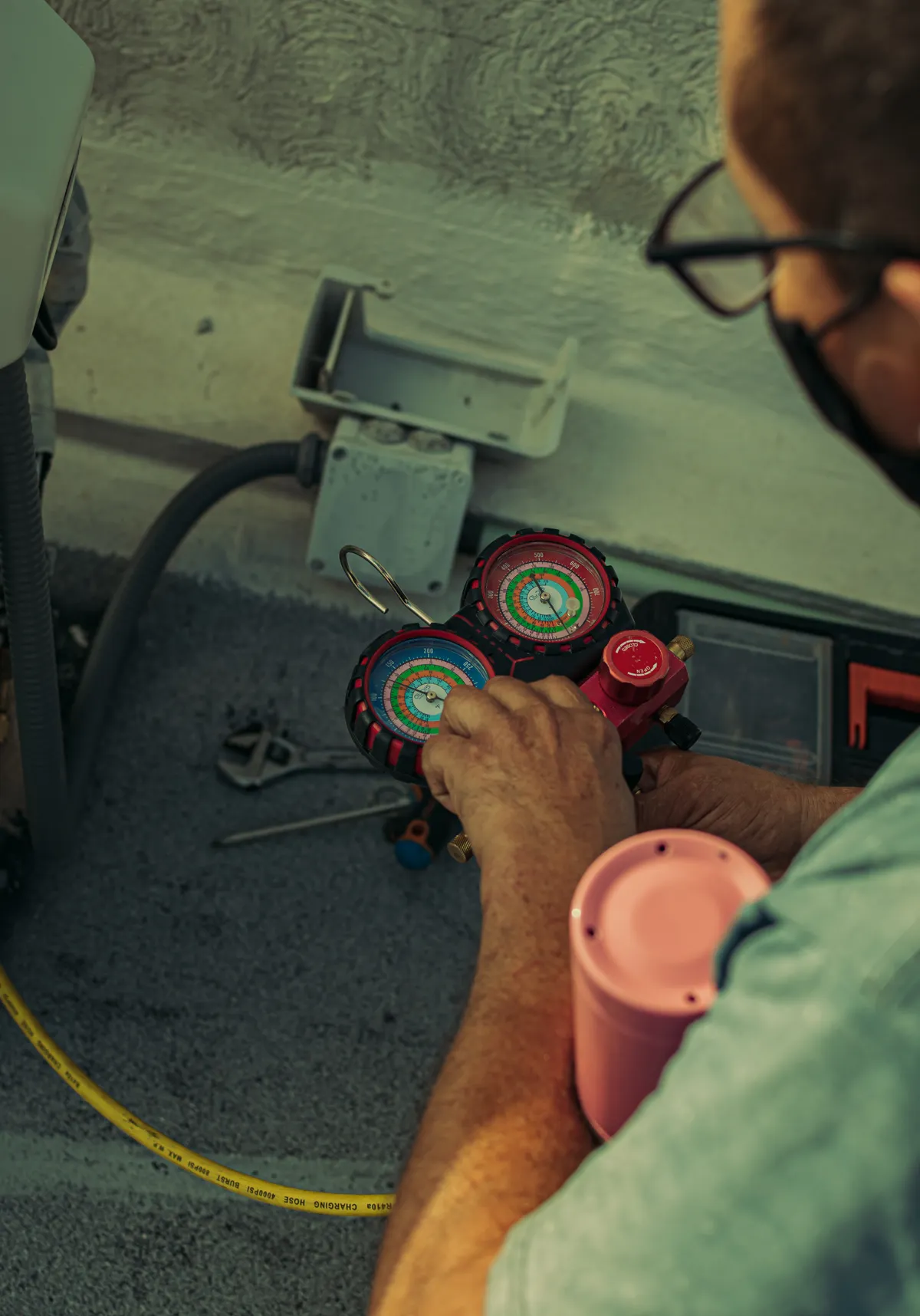 Technician performing air conditioner maintenance
